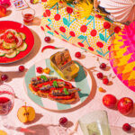 A vibrant picnic on a bright summer's day, featuring sardines on toast and a cucumber and tomato dish - photography competition submission